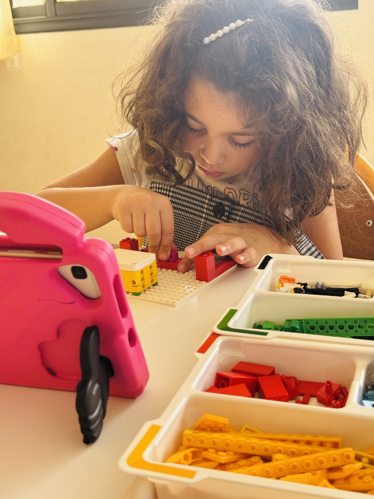 Une enfant construit un robot avec des briques au centre FADAA Al Maouhiba
